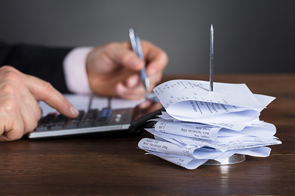 man calculating sales tax audit
