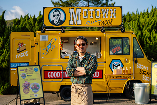 business owner in front of his food truck