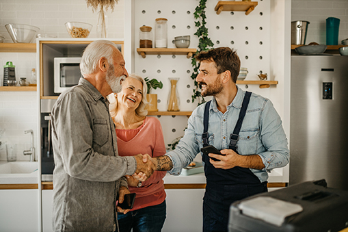 senior couple agreeing to trade deal with business owner
