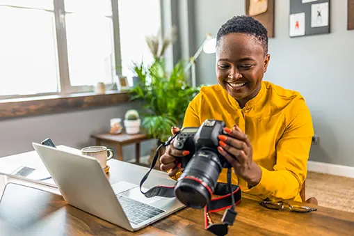 photographer going through photos and uploading to laptop