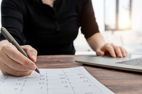 person organizing calendar for payment plan