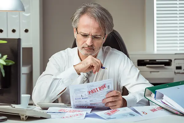 man going through his business tax payment plans